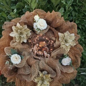 Hand-made bronze and gold deco mesh Christmas wreath with a Nativity scene of Baby Jesus in the manger at the centre, cream roses and gold glitter poinsettias – by Shamitay