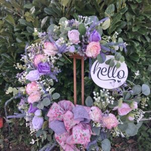 Lilac and pink floral wreath with roses, lavender, white blossom and a white "hello" sign – hand-made artificial wreath by Shamitay